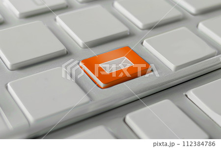 Close-up of a white keyboard with an orange email icon key. Email marketing or newsletter concept Close-up of a white keyboard with an orange email icon key. Email marketing or newsletter concept 112384786