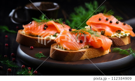 Sandwiches with cream cheese and smoked salmon on a dark wooden background Sandwiches with cream cheese and smoked salmon on a dark wooden background 112384909