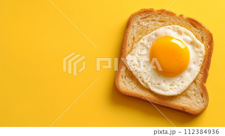 toast with fried egg, pastel yellow background,copy space 112384936