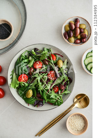 Salad with cherry tomato, olives, cucumber and arugula Salad with cherry tomato, olives, cucumber and arugula 112384995