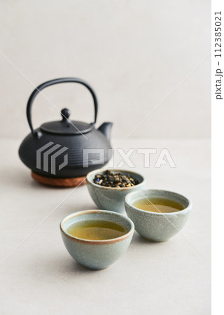 two ceramic cups of green tea two ceramic cups of green tea 112385021