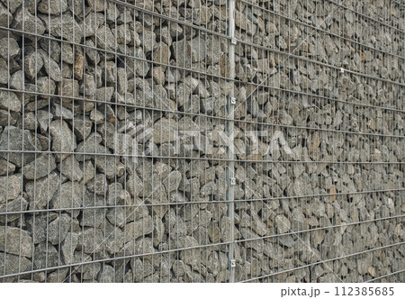 Construction. Modern technologies. Stone and steel mesh blocks. Construction. Modern technologies. Stone and steel mesh blocks. 112385685
