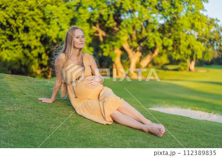 pregnant woman finds joy and serenity, relishing a tranquil moment outdoors during her pregnancy journey pregnant woman finds joy and serenity, relishing a tranquil moment outdoors during her pregnancy journey 112389835
