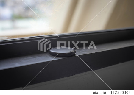 closeup of black button on a table closeup of black button on a table 112390305