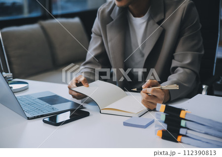Business team working with new startup project plan and discussion information for financial strategy with laptop and digital tablet in a modern business lounge. 112390813