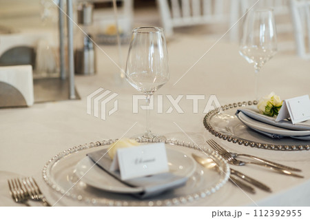 Cutlery and dishes on the table for guests at a wedding dinner in a restaurant Cutlery and dishes on the table for guests at a wedding dinner in a restaurant 112392955