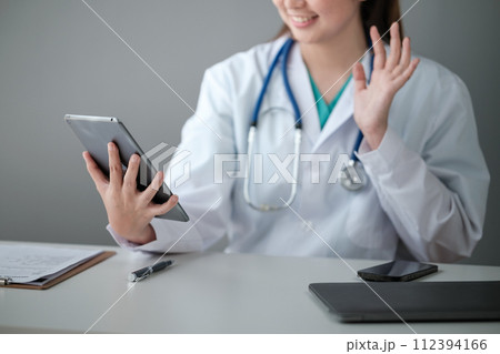 Doctor Having Video Conference On a Tablet With Colleagues 112394166