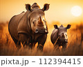 AI-generated content. Majestic rhinos roaming freely in the vast african savanna during the golden hour AI-generated content. Majestic rhinos roaming freely in the vast african savanna during the golden hour 112394415