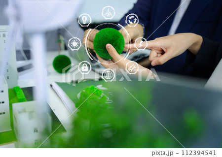 Business tam using tablet for working technology and business, Renewable energy-based green businesses and global warming. Reduce CO2 emission. Business tam using tablet for working technology and business, Renewable energy-based green businesses and global warming. Reduce CO2 emission. 112394541