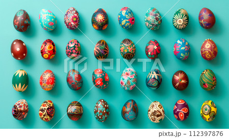 A row of colorful pastel Easter eggs, each uniquely painted with different texture on a green background A row of colorful pastel Easter eggs, each uniquely painted with different texture on a green background 112397876