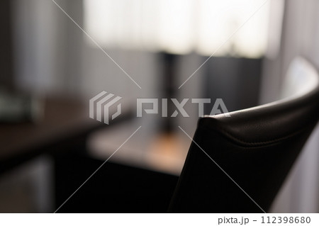 Blurred background of dining room with leather chair closeup Blurred background of dining room with leather chair closeup 112398680