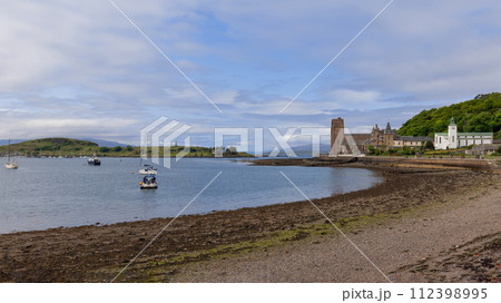 Serene Oban Bay waters dotted with boats near historic St Columba's Cathedral, Scottish sky above Serene Oban Bay waters dotted with boats near historic St Columba's Cathedral, Scottish sky above 112398995