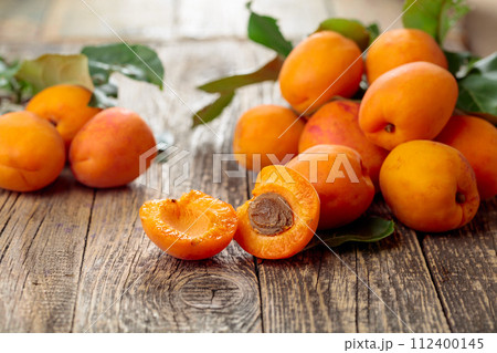 Fresh apricots on a old wooden table. Fresh apricots on a old wooden table. 112400145