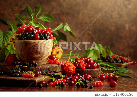Cherries, red and black currants on the kitchen table. Cherries, red and black currants on the kitchen table. 112400156