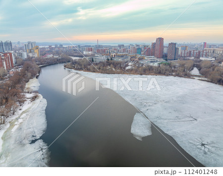 The spring river in the city is melting from ice. The ice on the river began to melt. Yekaterinburg, Russia 112401248