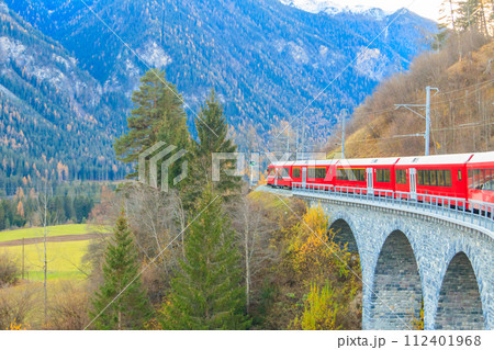 Red passenger train on Rhaetian railway in Canton Graubunden, Switzerland at autumn 112401968