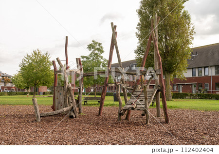 Rustic Wooden Playground in Suburban Park Rustic Wooden Playground in Suburban Park 112402404