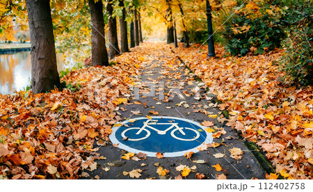 Bicycle Lane in a Public Park in Autumn - Generative Ai 112402758