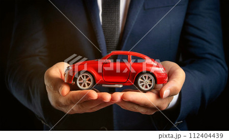 Businessman in Formal Clothing Holding a Red Miniature Car - Generative Ai 112404439