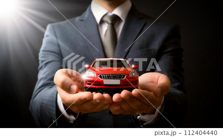 Businessman in Formal Clothing Holding a Red Miniature Car - Generative Ai 112404440