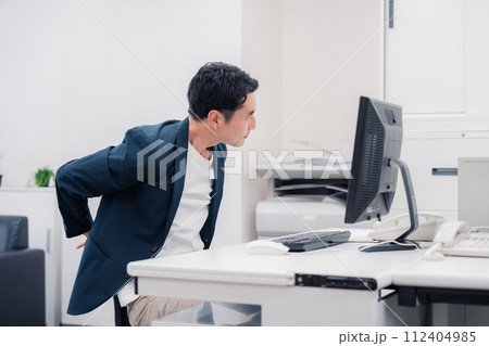 長時間労働でドライアイに苦しむビジネスマン 112404985