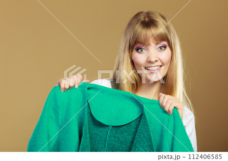 Fashionable woman showing green coat Fashionable woman showing green coat 112406585