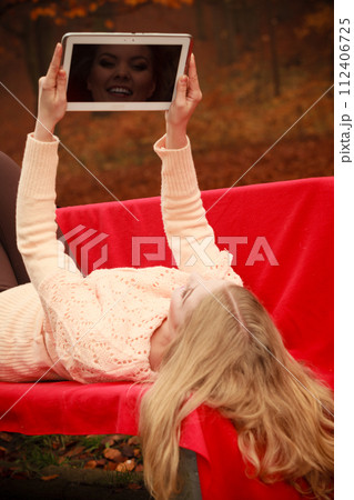 Girl sitting on bench with tablet. 112406725