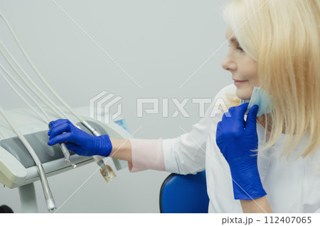 Male smiling during her dental treatment at dentist. Male smiling during her dental treatment at dentist. 112407065