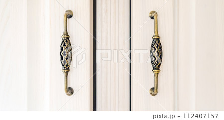White cabinet with vintage door handles. 112407157