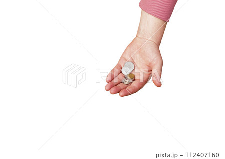 Last money for groceries. Coins in the hand of a middle-aged woman. The concept of the world food crisis associated with the war in Ukraine. Isolated on white background Last money for groceries. Coins in the hand of a middle-aged woman. The concept of the world food crisis associated with the war in Ukraine. Isolated on white background 112407160