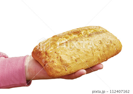 Bread in the hand of a middle-aged woman. The concept of the world food crisis associated with the war in Ukraine. Isolated on white background Bread in the hand of a middle-aged woman. The concept of the world food crisis associated with the war in Ukraine. Isolated on white background 112407162