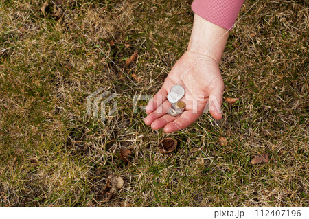 Last money for groceries. Coins in the hand of a middle-aged woman. The concept of the world food crisis associated with the war in Ukraine Last money for groceries. Coins in the hand of a middle-aged woman. The concept of the world food crisis associated with the war in Ukraine 112407196