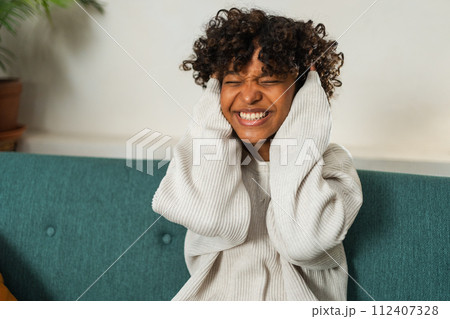 Beautiful African American girl with afro hairstyle smiling. Close up portrait of young happy black girl. Young African woman with curly hair laughing. Freedom happiness carefree happy people concept 112407328