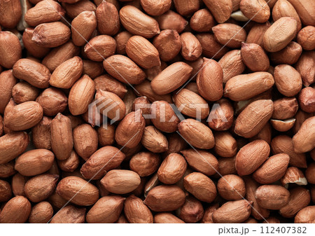 Raw peeled red peanut nuts top view macro background. Raw peeled red peanut nuts top view macro background. 112407382