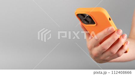 Berlin Germany January 21 2024 Hand holding mobile phone, iphone smartphone. Banner background 112408666