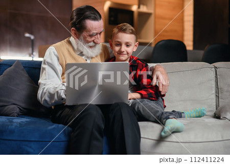 Grandson is teaching his grandfather to use laptop computer. Grandson is teaching his grandfather to use laptop computer. 112411224