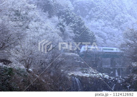 雪の舞う田原の滝と富士急行 112412692