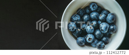 Freshly picked blueberries in a bowl. Juicy and fresh berries on a rustic table. Healthy food 112412772