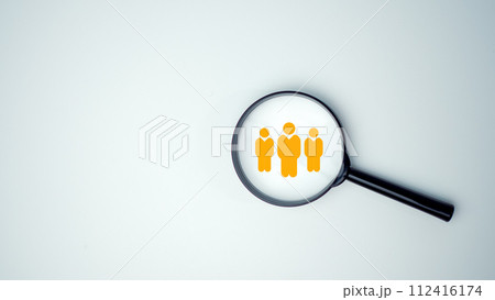 Customer group icons in a magnifying glass placed on a white background represent the selection of business goals, target customers, Marketing plans and strategies, customer-centric strategies. 112416174