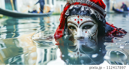 Venetian Mask Reflected in Water at Sunset Venetian Mask Reflected in Water at Sunset 112417897
