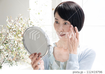 ビューティ　窓辺で鏡を持つ女性 112419796