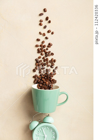 Coffee Beans Streaming Over Alarm Clock 112420336