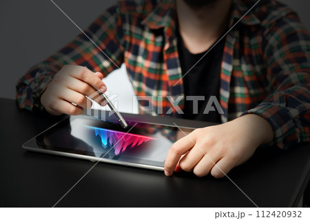 Male hands touching digital tablet with business diagram. Businessman using tablet analyzing sales data and economic growth graph chart. Concept of growth planning and business strategy 112420932