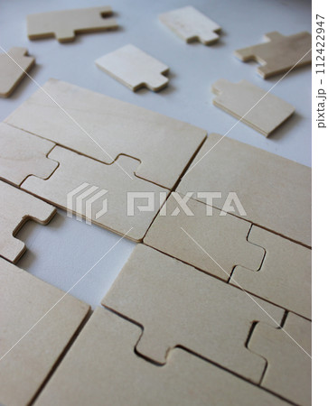 One missing piece in a rectangle assembled from wooden puzzles One missing piece in a rectangle assembled from wooden puzzles 112422947