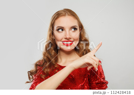 Attractive fashion model woman pointing up on white background. Beautiful lady Attractive fashion model woman pointing up on white background. Beautiful lady 112428418