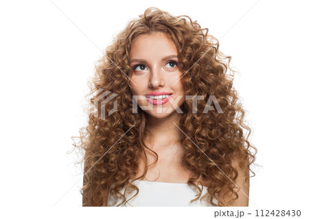 Friendly young healthy lady looking up portrait. Perfect woman with long frizzy hairstyle 112428430