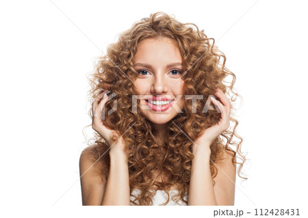 Cheerful healthy model with natural make-up, shiny clear skin and long curly hairstyle. Cheerful healthy model with natural make-up, shiny clear skin and long curly hairstyle. 112428431