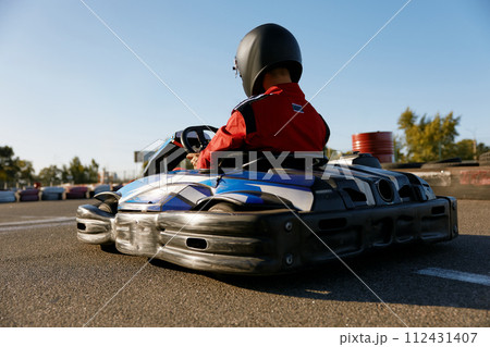 Back view shot of competitive racer driving go-cart sports track 112431407