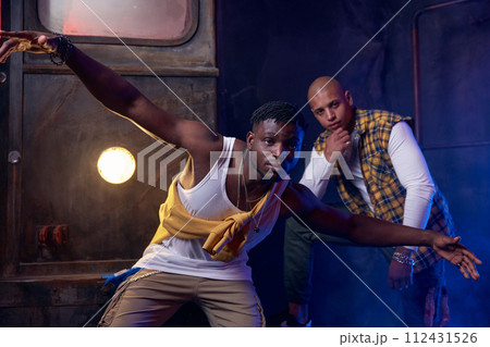 Two modern hip-hop dancers in garage performing urban freestyle dance Two modern hip-hop dancers in garage performing urban freestyle dance 112431526