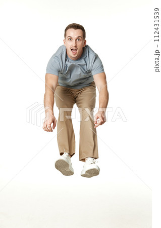 happy guy looking pointing at the camera on white studio background 112431539